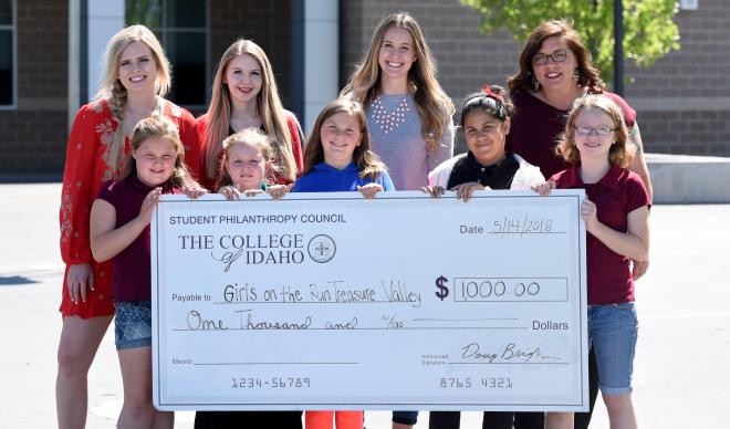 Representatives of the Student Philanthropy Council present a check for $1,000 to Girls on the Run Treasure Valley. 