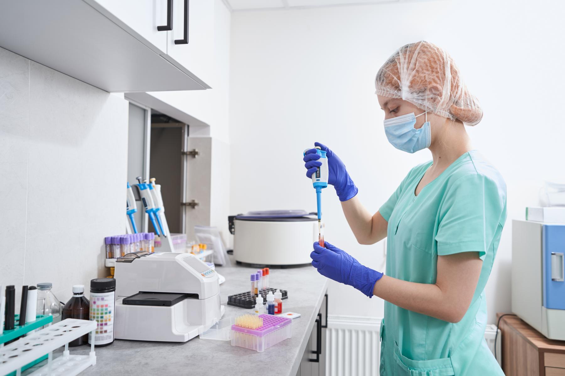 woman-taking-liquid-for-research-in-laboratory