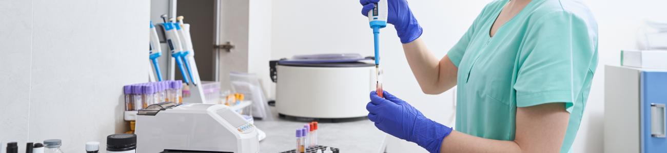 woman-taking-liquid-for-research-in-laboratory